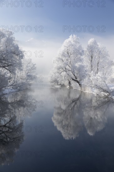 Lake Kochelsee in Bavaria, Germany. River Loisach leaving the lake. Winter, hoar frosted trees