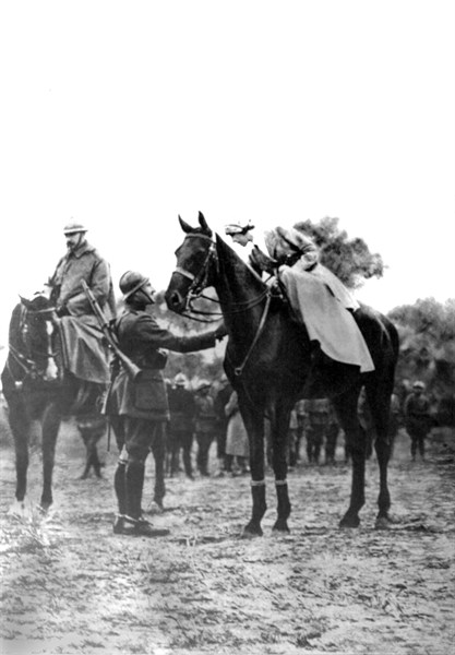 World War I. The Queen of the Belgians salutes a rider in the course of a medal ceremony (1918)
