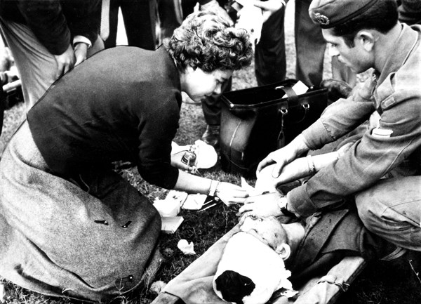 Queen Frederika treating soldiers injured during the war