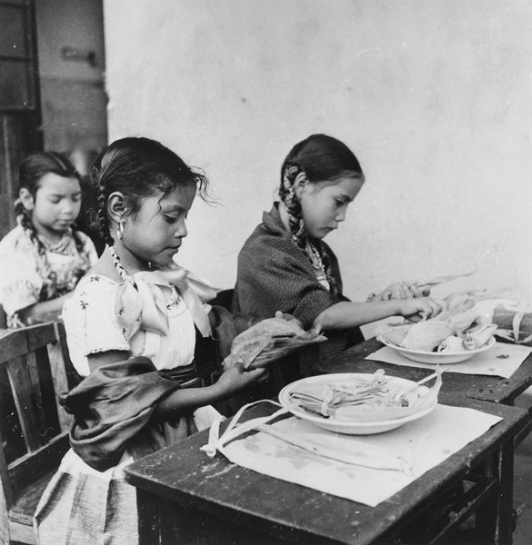 Mexican girls preparing fish tamales