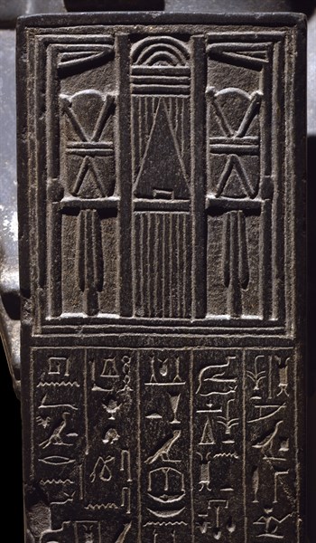 Statue of the priest Henat featuring tabernacle with the facade of the temple of the Goddess Neith a Sais