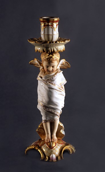 Candle holder with vettoed cherub