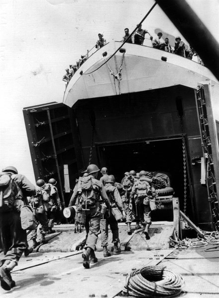 U.S combat enginner unit march aboard a landing ship (England) June 1944