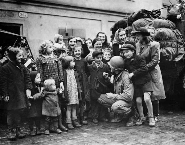 Czechoslovak children surround U.S. soldier in Pilsen May 6, 1945