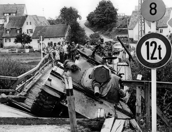 A bridge collapses under the weight of a U.S. tank