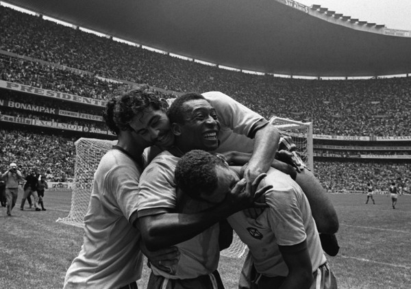 Pele is celebrating with his teammates, Roberto RIVELINO on top of them, after the 1970 FIFA World