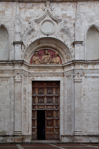 Montepulciano, church of St. Augustine: detail of the portal with the lunette with the terracotta