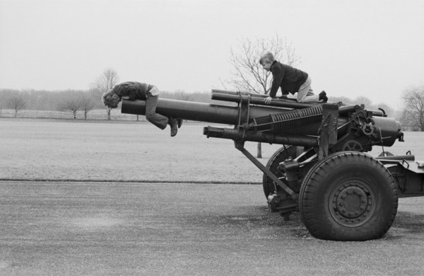 Two Boys Playing on Old Cannon