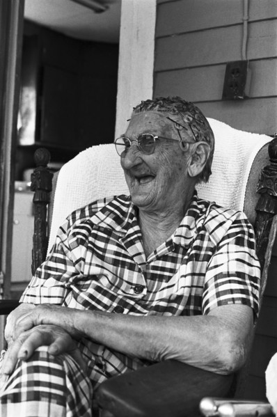 Elderly Woman Sitting on Porch