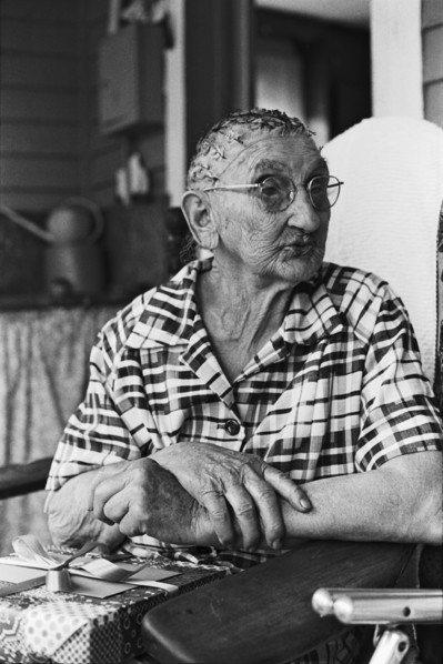 Elderly Woman Sitting on Porch