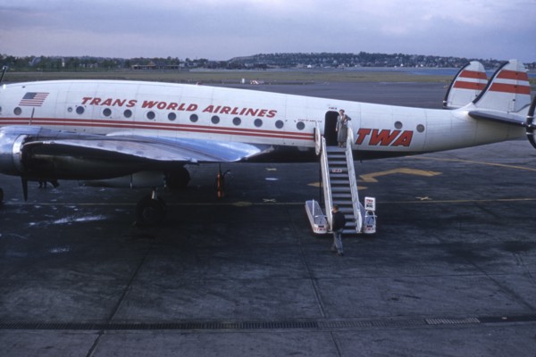 Stewardess Standing at top of Stairs of TWA Airplane, Circa 1950's