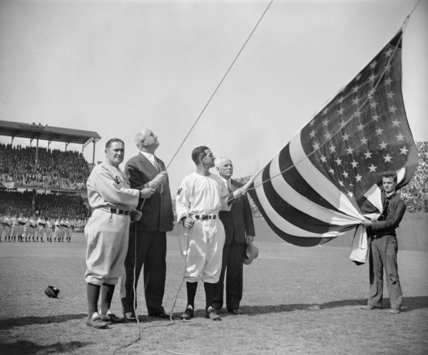 New York Yankee Manager Joe McCarthy, Postmaster General James A. Farley, Washington Senator's Manager Bucky Harris, and Clark Griffith, owner of Senators, Raising Flag before First Baseball Game of S...