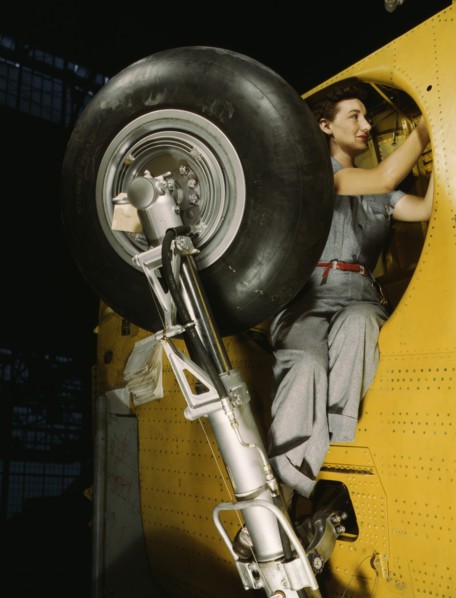 Female Worker Making Final Adjustments in Wheel Well of Inner Wing Before Installation of Landing Gear, Vultee "Vengeance" Dive Bomber, Nashville, Tennessee, USA, Alfred T. Palmer for Office of War In...