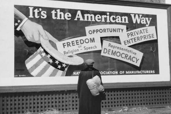 Man Standing in front of National Association of Managers Billboard, Dubuque, Iowa, USA, John Vachon for Farm Security Administration, April 1940