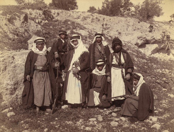 Bedouin Men of Arakat Tribe, Portrait in Rocky Landscape with Swords and Rifles, American Colony Photo Department, early 1900's