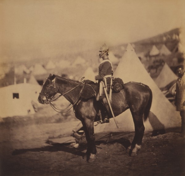 British Major Adolphus Burton, 5th Dragoon Guards, Seated Portrait in Uniform on Horse, Conical Military Tents in Background, Crimean War, Crimea, Ukraine, by Roger Fenton, 1855