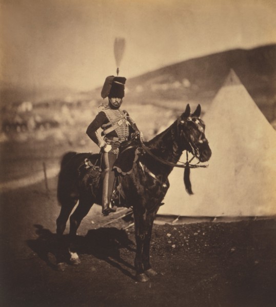 British Cornet Henry John Wilken, 11th Hussars, Seated Portrait in Uniform on Horse, Conical Military Tents in Background, Crimean War, Crimea, Ukraine, by Roger Fenton, 1855