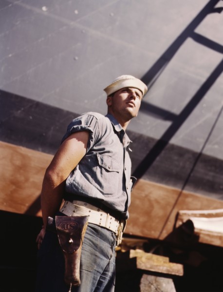 Coast Guard Sentry Standing Watch over New Torpedo Boat Under Constructions at Shipyard, Higgins Industries, Inc., New Orleans, Louisiana, USA, Howard R. Hollem for Office of War Information, July 194...
