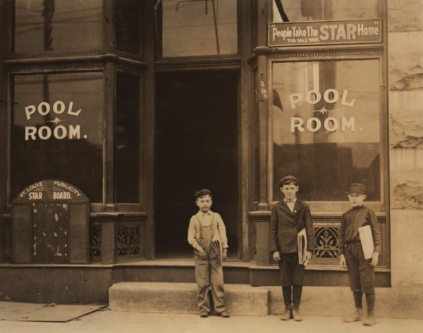 Three Young Newsboys, Portrait Standing outside Pool Hall after Receiving Afternoon Newspapers, Boys were Smoking and Playing Pool while Waiting for Papers, Youngest Boy is 9 years old and Sells until...