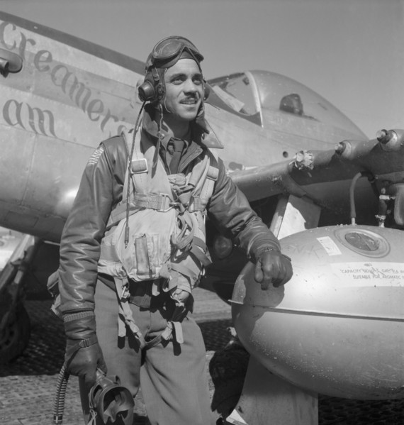 Tuskegee Airman Edward C. Gleed of Lawrence, Kansas, Class 42-K, Group Operations Officer, Three-quarter Length Portrait, Wearing Flight Gear, with Left Arm Resting on Airplane at Air Base, Ramitelli,...
