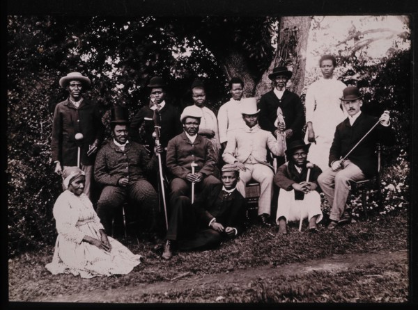 Group of Zulu Men and Women in Western Clothes With a British Gentleman, South Africa, circa 1890