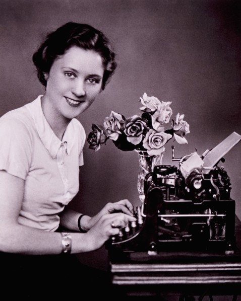 Smiling Woman Typing on Typewriter, circa 1930's