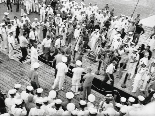 Astronauts Virgil "Gus" Grissom and John Young on Red Carpet on U.S.S. Intrepid on way to Debriefing after Completion of Gemini 3 Space Mission, 1965