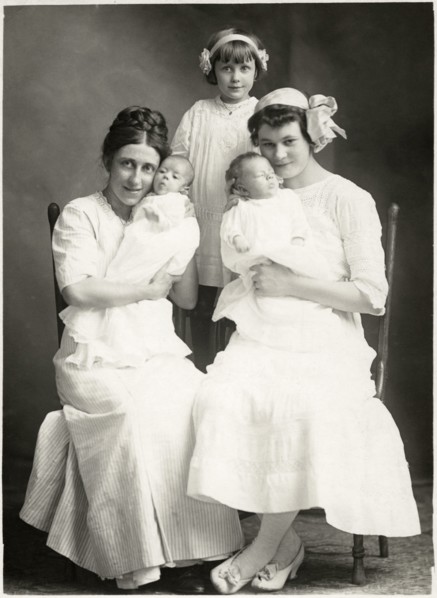 Two Seated Women Holding Newborn Infants with Young Girl Standing in Rear, Portrait, circa 1920
