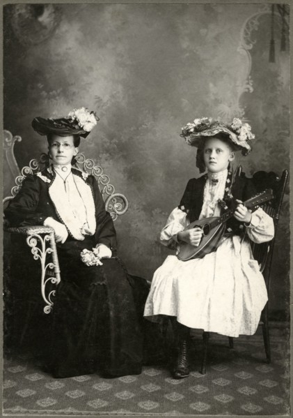 Seated Older Woman  in Long Dress and Hat Sitting Next to Young Girl Holding Lute, Cabinet Card, circa 1911