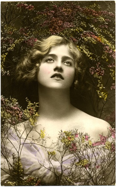 Woman in Pale Purple Dress Looking Up, Surrounded by Tiny Flowers, Hand-Colored Postcard, circa 1910's
