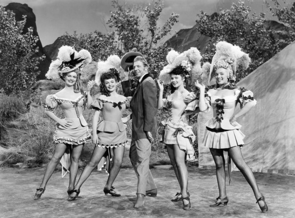 Dan Dailey, with Chorus Girls Marion Marshall, Joyce Mackenzie, Barbara Smith, Marilyn Monroe, on-set of the Film "A Ticket to Tomahawk", 1950