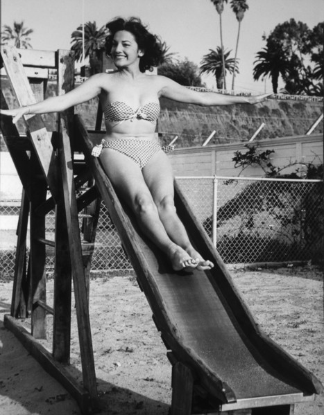 Actress Charlita, Publicity Portrait on Slide in Two-Piece Bathing Suit, circa 1955