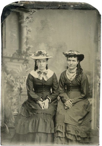 Portrait of Two Adult Women in Hats and Long Dresses, Both Seated with Hands Folded, Studio Shot, circa 1870