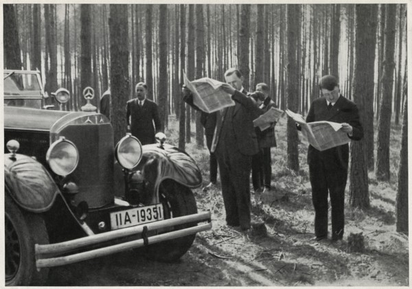 Adolf Hitler and Entourage Standing Alongside his Mercedes while Reading Newspapers in the Woods, Germany, early 1930's