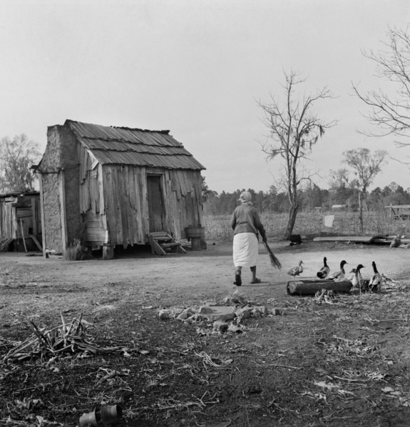 Woman Walking in Yard by Rural Cabin, near Beaufort, South Carolina, USA, Marion Post Wolcott, Farm Security Administration, December 1938