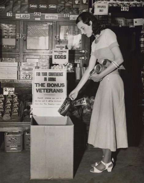 Miss Mary Wick Placing Bag of Coffee in Food Box placed in Stores to Receive Contributions for Encamped Bonus Army Veterans, Washington DC, USA, Underwood and Underwood, June 1932