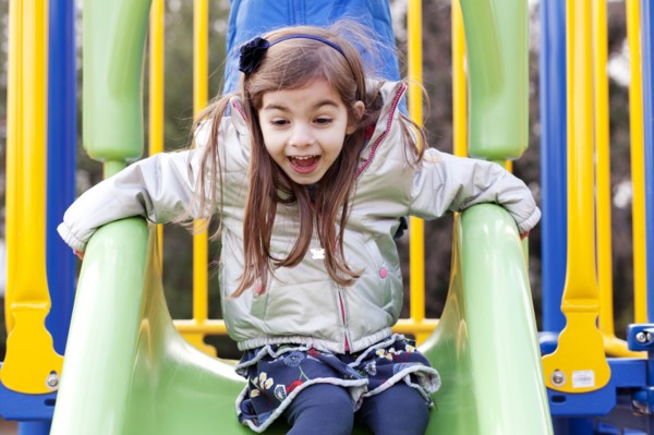 Girl on Playground Slide