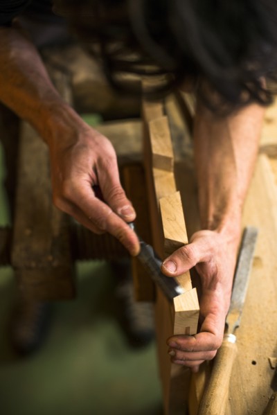 Woodworker Using Chisel on Piece of Wood, High Angle View