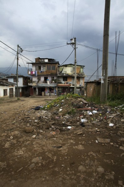 Poor Neighborhood With Pile of Garbage on Dirt Street, Medellin, Colombia