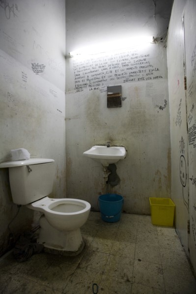 Dirty Bathroom With Writing on Walls