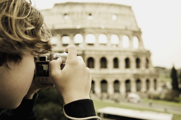 Young Boy Taking Photo of Colosseum, Rome, Italy