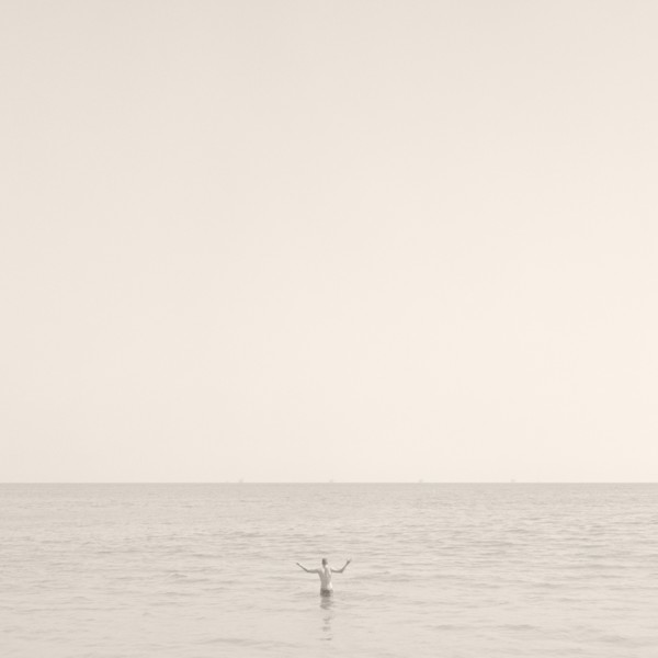 Man Standing in Ocean, Rear View