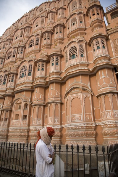 Indian Man Walking by Ornate Building in Pink City