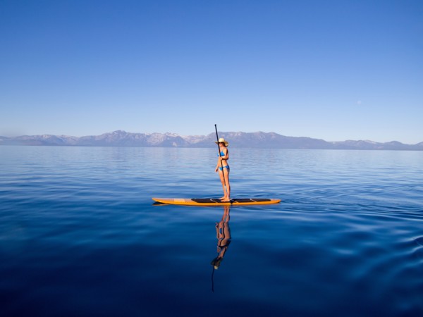 Woman Standing on Paddleboard Holding Paddle