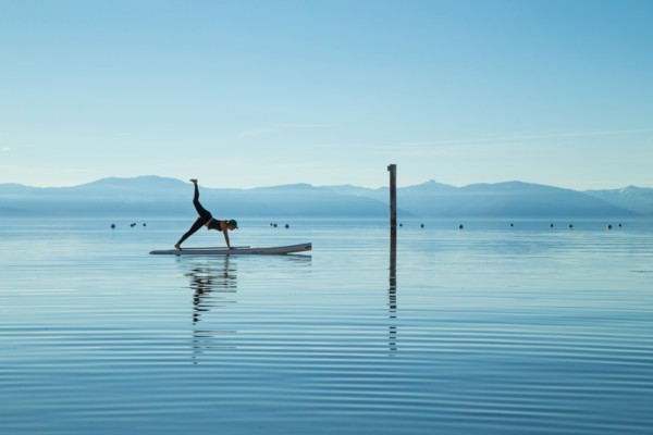 Woman in Yoga Pose on Paddle Board on Lake, Lake Tahoe, Nevada, USA