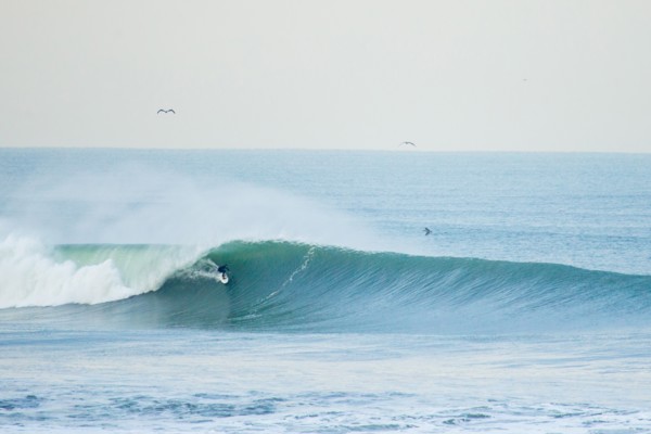 Surfer in Wetsuit Riding Wave, San Francisco, California, USA