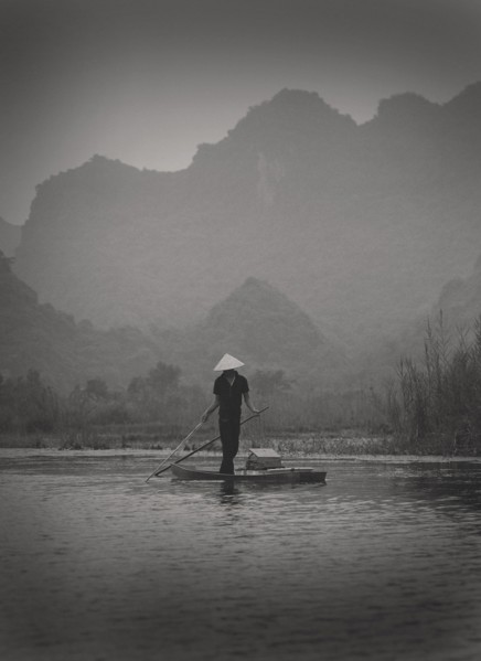 Fisherman Standing on Small Boat, Vietnam