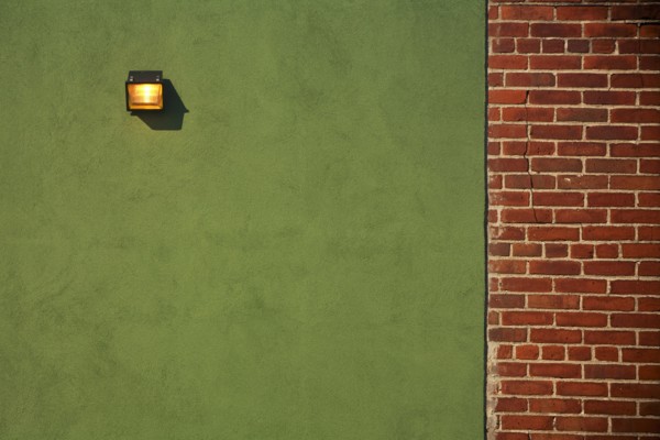 Light Fixture on Green Wall With Red Brick Wall Border
