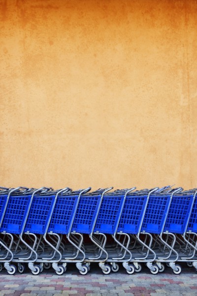 Line of Blue Shopping Carts Against Colorful Wall