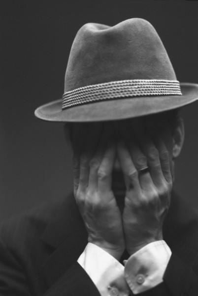 Distressed Man in Hat
